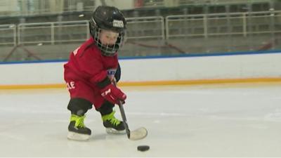 Toddler playing hockey