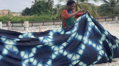 A woman holding a indigo cloth