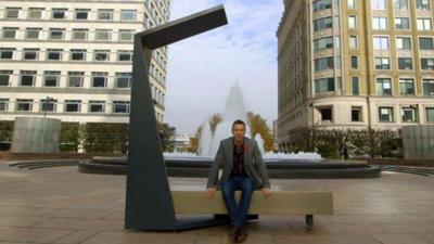 BBC Click's Spencer Kelly sits on a solar bench
