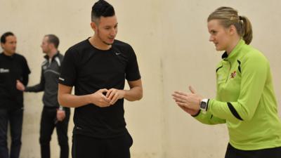 Nick Bright receives a handball lesson from world champion Aisling Reilly