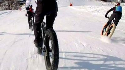 Bikers brave ice and snow for a high-speed race through the Swiss mountains.