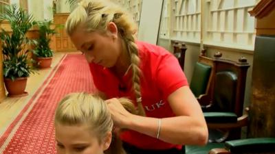 Lara Kenny plaiting a girl's hair