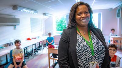 Headteacher Allana Gay and pupils smiles