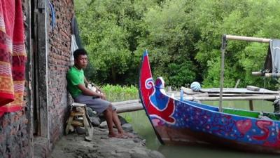 A man sits with his boat