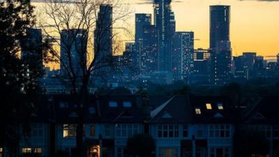 A night view of tower blocks over London.