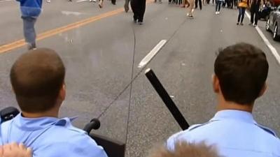 Unverified footage from behind police lines shows officers using shields to protect themselves from objects being thrown by protesters