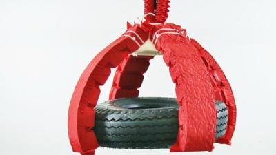 A soft robot lifting a car tyre