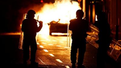 Police officers stand in front of a fire in Dublin