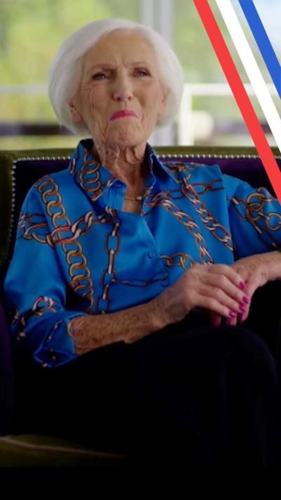 Mary Berry sat in an armchair smiling at the camera