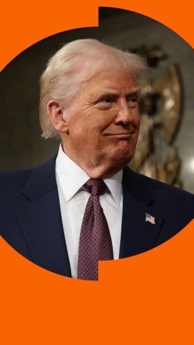 Donald Trump in a suit and tie, looking to the right 