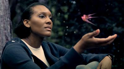 Woman with a fish floating above her hand