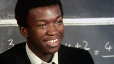 A student in front of a blackboard.