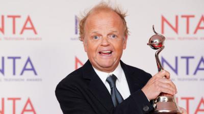 Actor Toby Jones holding his award