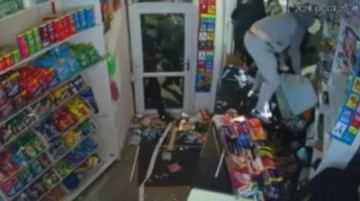 Looters stand on the shop counter pick up items