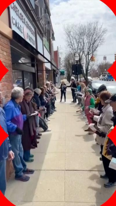People form two lines of human chain and pass books.