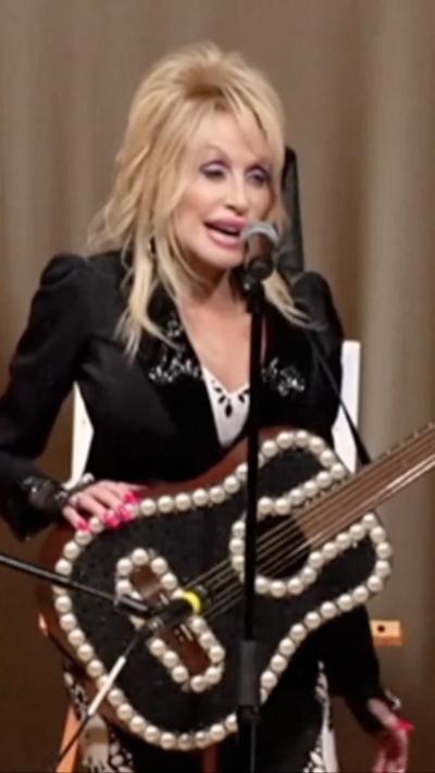 Dolly Parton in Kentucky with a black guitar