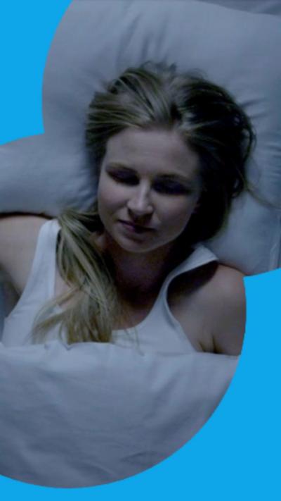 A woman with her eyes closed in bed