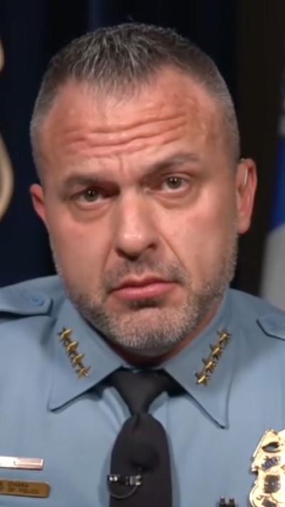 O'Hara wearing police uniform and looking into the camera