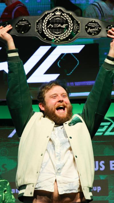 A person holding up the Microsoft Excel world championship belt