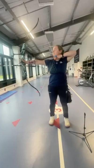 An archer in a blue outfit 