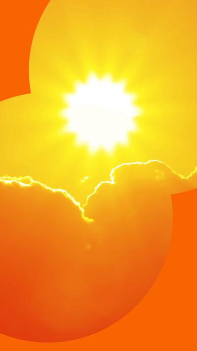 Orange sky with sun and clouds during hot summer weather