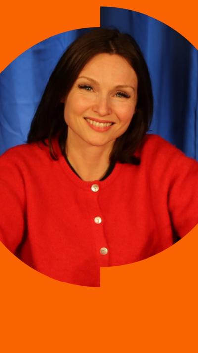 Sophie Ellis-Bextor has dark hair and is wearing a red cardigan.