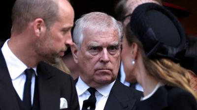 Prince Andrew stands behind the Duke and Duchess of Cambridge at the Duchess of Kent's funeral