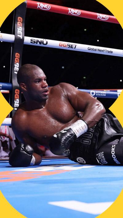 Daniel Dubois lying on the canvas in a boxing ring looking stunned