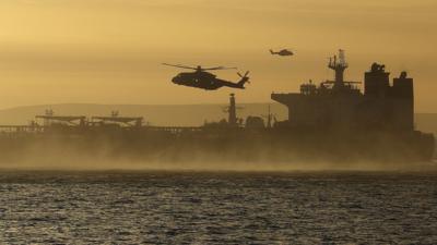 A helicopter in the sky above a seized tanker in the English Channel 