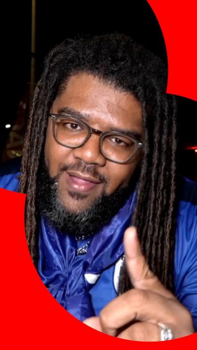 Man with long hair and blue top