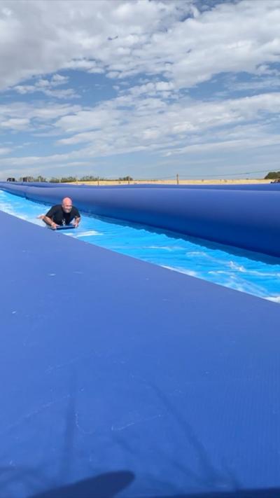 A man uses the slip and slide