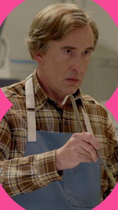 Alan Partridge holding a soup ladle and looking at someone in a judgemental way