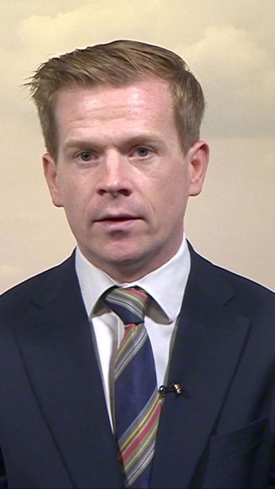 Nick Eardley wearing a tie with a multicoloured stripe through it