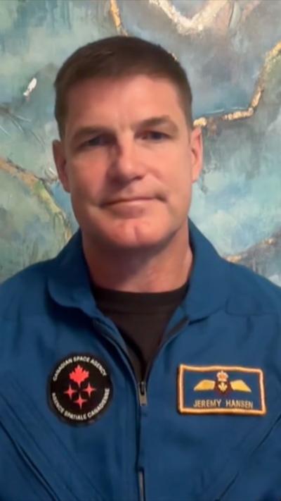 Canadian astronaut Jeremy Hansen in blue flight suit