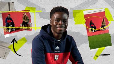 Bukayo Saka smiles in a blue and red Arsenal hoodie with two images from The Football on either side of him