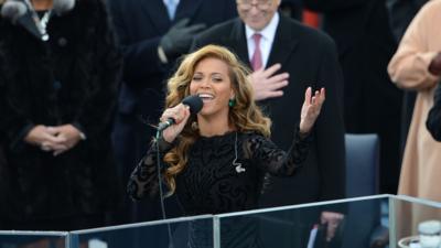 Beyoncé singing with her arm raised at the Obama inauguration