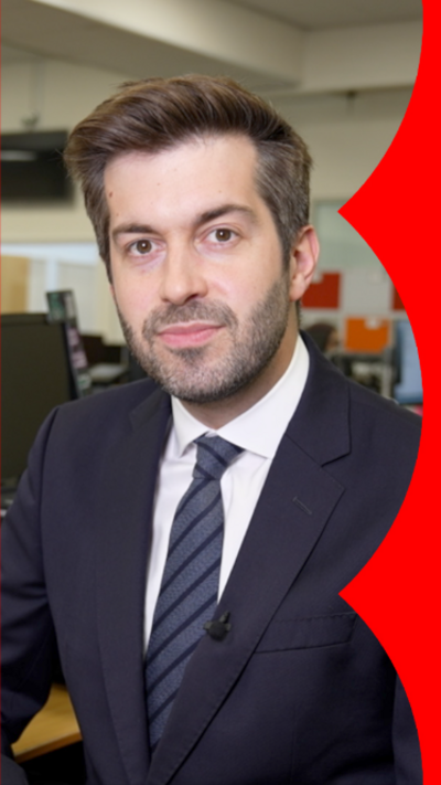 Joe Pike in a black suit with a grey tie