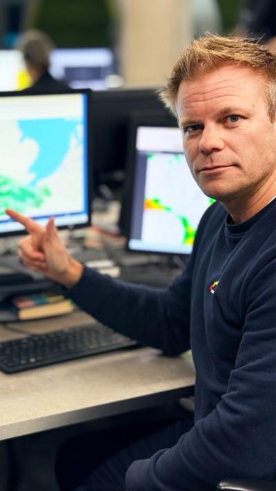 BBC Weather Presenter Simon King pointing at screens tracking Storm Goretti