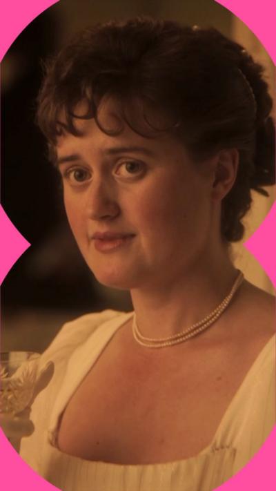 A woman with dark tied-back curly hair wearing a white dress