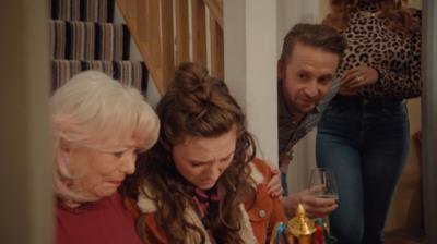 Amy sits on the stairs, surrounded by her family.