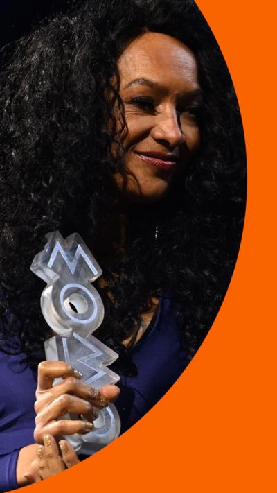 MOBOs founder Kanya King holds one of the awards during the 2026 ceremony.