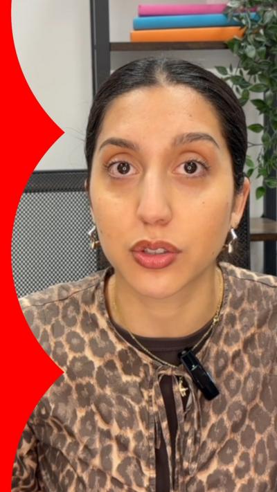 Reporter Hannah Karpel has black hair and is wearing a leopard print blouse.