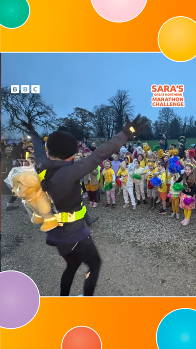 Sara Cox waves at schoolchildren