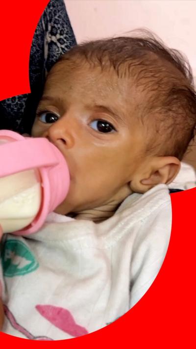 Yasmeen Abu Sultan's two-month-old daughter a bottle