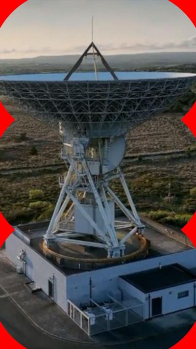 The Goonhilly satellite dish stands amid a backdrop of a clear sky.