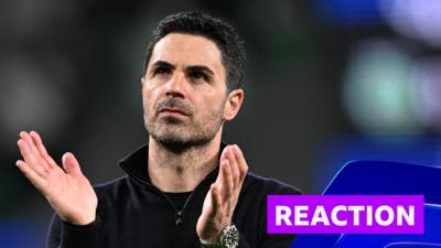 Mikel Arteta looks towards crowd and does a clapping hand motion 