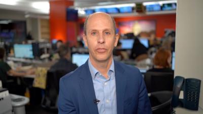 Anthony Zurcher wearing a suit in a newsroom