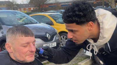 Barber and customer, who is homeless