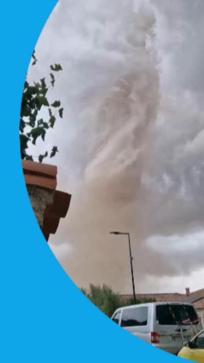 Image of tornado with a car in the foreground