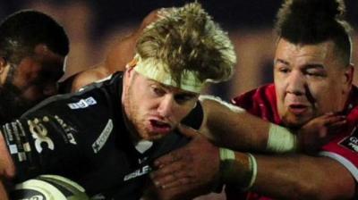 Aaron Wainwright tries to get past Scarlets' Javan Sebastian